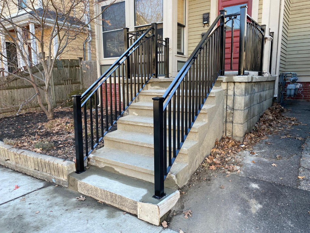 Custom black metal railings on residential concrete steps — Irias Iron Works