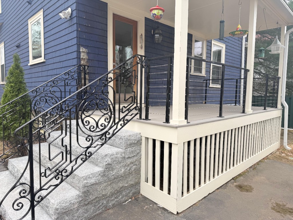 Traditional stair railings and modern cable railing on a residential porch