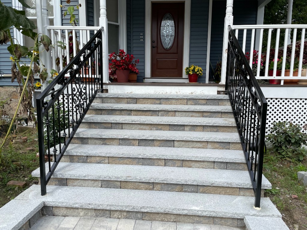 Decorative metal railings on stone steps with custom scrollwork