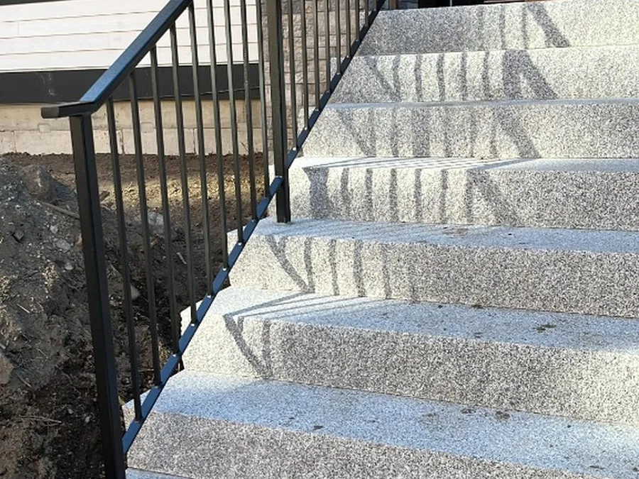 Custom black iron railing on exterior stone steps