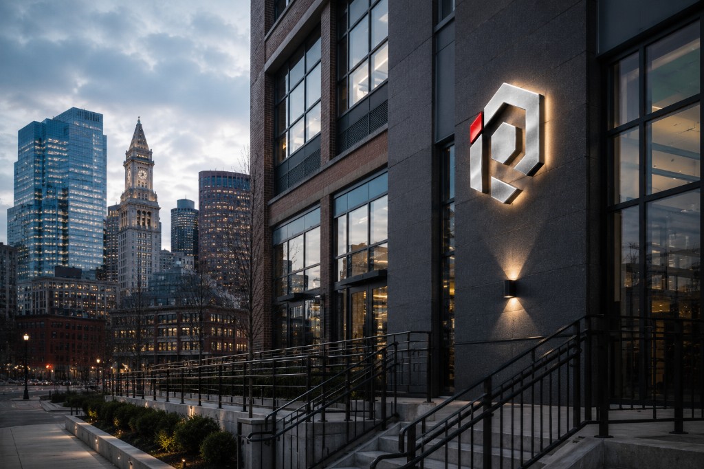 Commercial building with iron railings and illuminated signage, annual iron works maintenance by Irias Iron Works in Massachusetts