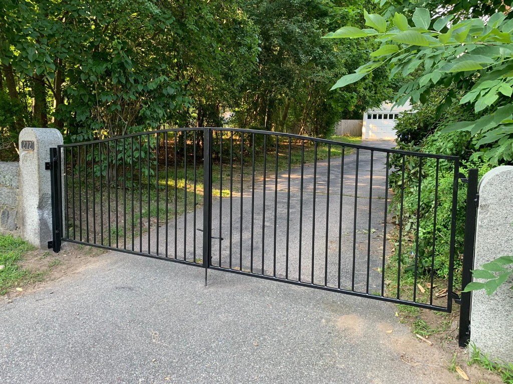 Double-swing black metal driveway gate with stone pillars — Massachusetts install
